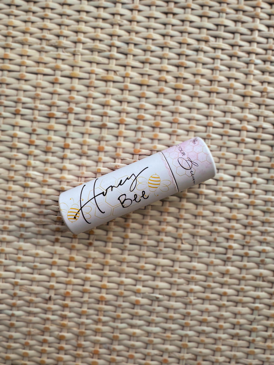 'Honey Bee' beeswax lip balm in a white tube with bees on it 