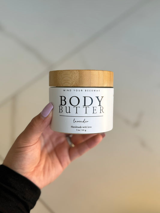 Mind your beeswax natural body butter in a white tub with a wooden lid