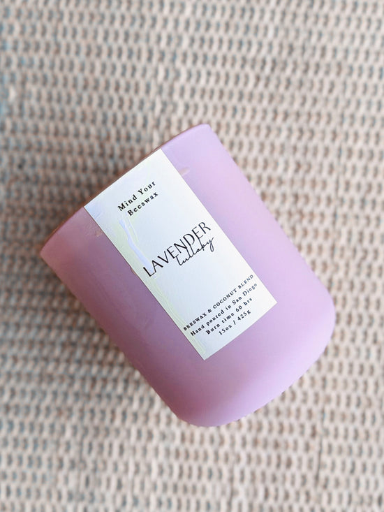 Natural beeswax hand poured candle in a pale purple jar, with text that reads 'lavender lullaby'